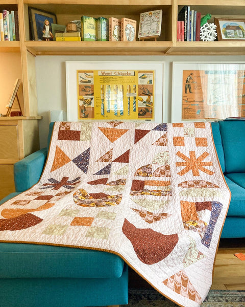 View of the building block quilt on a blue couch